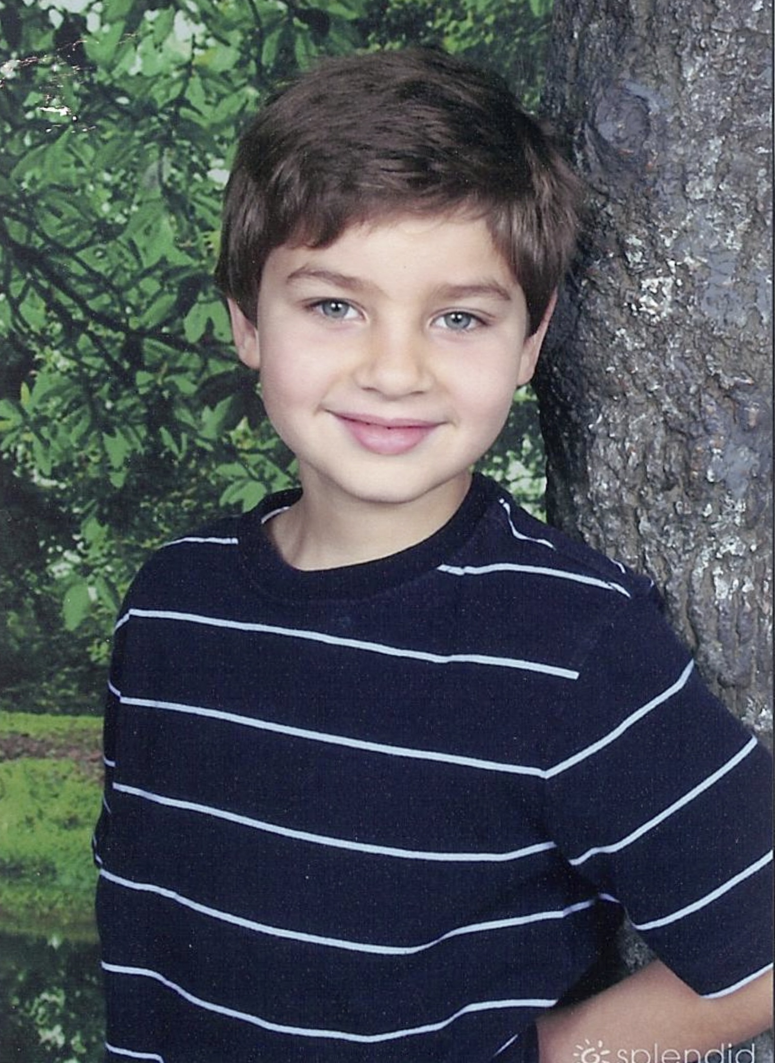 boy in front of tree